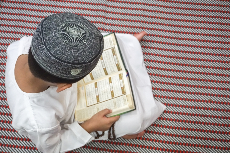 Kid reading Quran